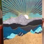 Sun peeks over granite mountain