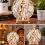 Product Name: Maa Mahagauri Tabletop Devotional Frame Goddess: Maa Mahagauri (depicted in a serene white and gold saree, resting peacefully alongside a white bull against a scenic mountain backdrop, holding a pink lotus) Design: Premium round acrylic plaque featuring a decorated golden border with white floral accents and crystal beads Stand: Natural wooden tripod easel stand for sturdy tabletop placement Dimensions: 4-inch acrylic round artwork, 5-inch wooden easel stand Ideal For: Home mandir, living room table, garden space decor, or spiritual gifting
